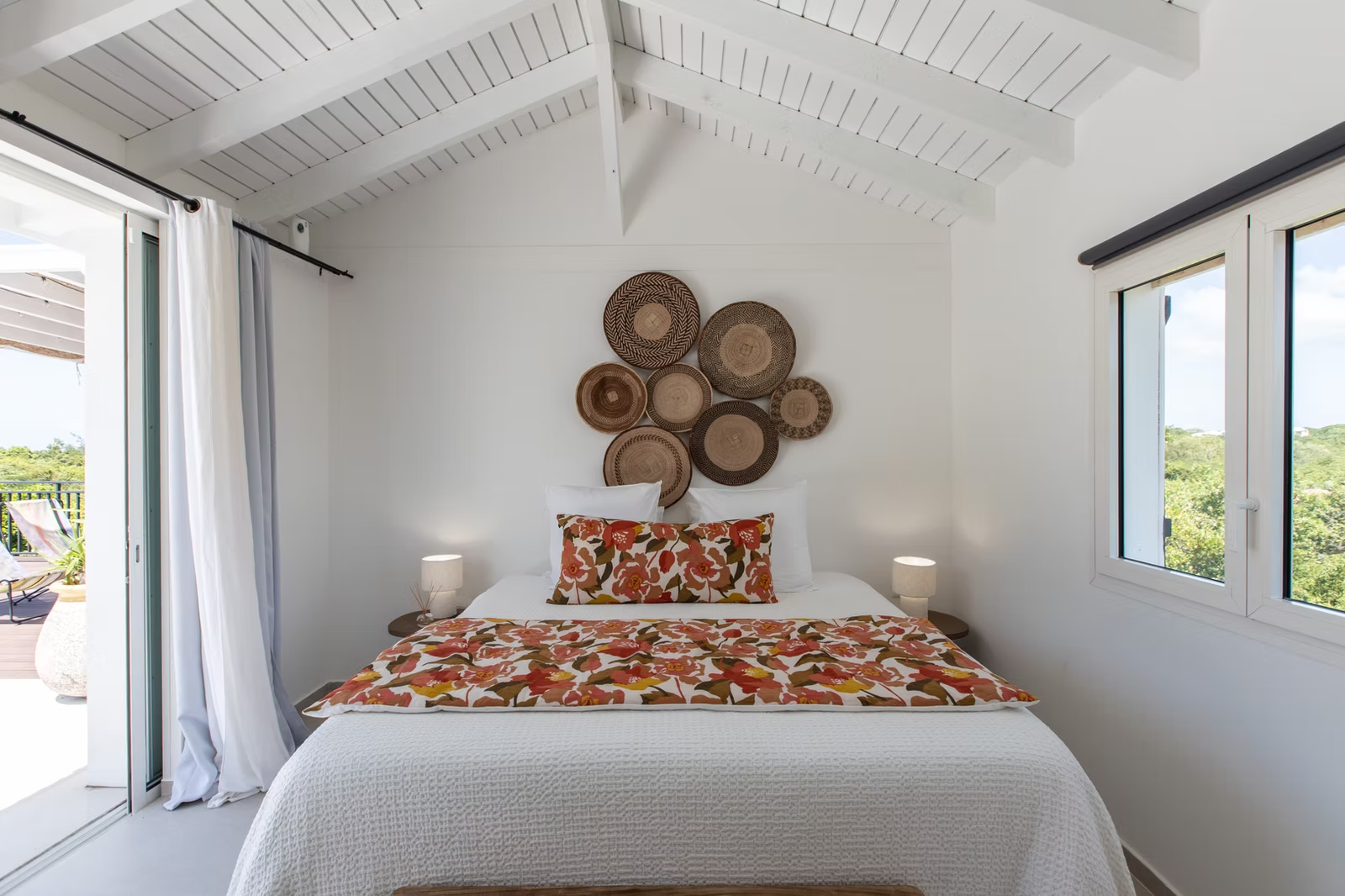 Bright bedroom at Villa Les Oliviers beneath white Caribbean rafters